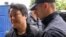 Do Kwon is escorted to court in Podgorica on May 11, 2023.