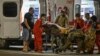 Ukrainian medical workers and servicemen treat a wounded local resident at the site of a Russian missile strike on Kryviy Rih on August 27. 