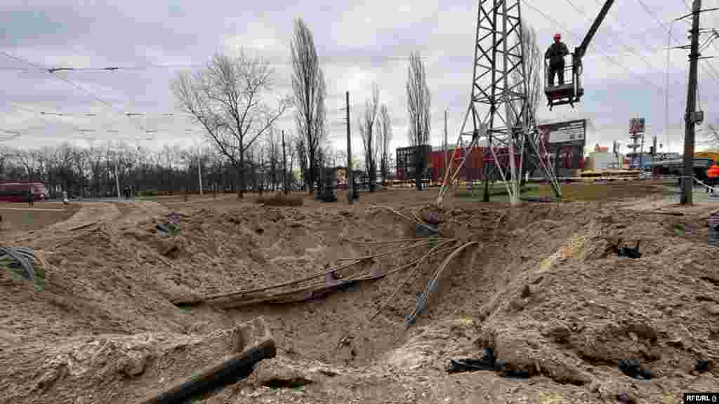 Kyiv municipal workers repair high-voltage lines that were damaged during the attack.
