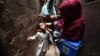 A health worker administers polio vaccine drops to a child during a door-to-door vaccination campaign in Karachi in June.