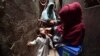 A health worker administers polio vaccine drops to a child during a door-to-door vaccination campaign in Karachi, Pakistan.