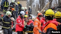 Rescuers remove the body of a local resident from an apartment building in Odesa that was heavily damaged by a Russian drone strike on March 2. 