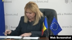 Moldova's central bank Governor Anca Dragu signs the application to join the Single Euro Payments Area in Chisinau on January 30.