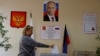 A woman casts her ballot at a polling station during elections held by the Russian-installed authorities in Donetsk on September 9.