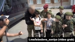 Wagner mercenary fighters instruct children at a "military-patriotic" club near Minsk in 2023 in this screen grab from a video posted by state TV commentator Ksenia Lebedeva