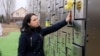 Ukraine - Natalia, whose uncle was killed by Russian troops, visits a memorial to victims of the massacre in Bucha - screen grab