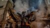 Rescuers work at the site of an apartment building heavily damaged by a Russian drone strike in Sumy, Ukraine, on March 13.