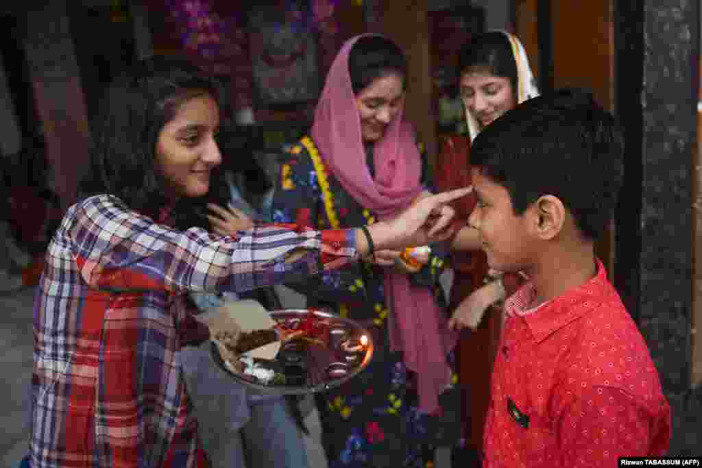 Pakistani Hindu girls celebrate the Raksha Bandhan festival at a temple in Karachi.