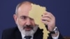 Armenia - Prime Minister Nikol Pashinian holds a cardboard cutout of Armenia at a news conference in Yerevan, March 12, 2024,