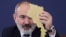 Armenia - Prime Minister Nikol Pashinian holds a cardboard cutout of Armenia's map at a news conference in Yerevan, March 12, 2024,