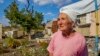 UKRAINE -- Vera Chernukha, 73, looks on as she stands next to her damaged house in the village of Dementievka, about eight kilometers from the border with Russia, Kharkiv region, Ukraine, 18 September 2023.