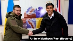 Ukrainian President Volodymyr Zelenskiy and British Prime Minister Rishi Sunak sign a declaration of unity during his first visit to the United Kingdom since the Russian invasion of Ukraine at a military facility in Lulworth, Dorset, Britain, on February 8.