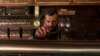 Mostar, Bosnia and Herzegovina -- A waiter pouring a drink in a local café 