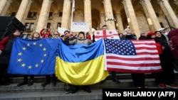 Georgians protest outside their country's parliament building on March 8 against a controversial draft law on "foreign agents."