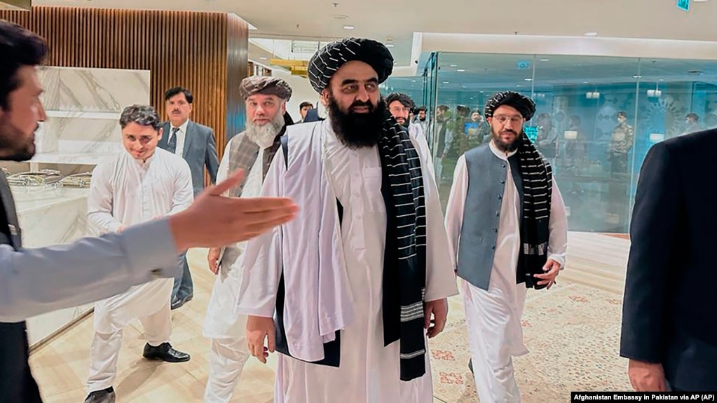 The Taliban-appointed Foreign Minister Amir Khan Muttaqi (center) walks with other officials after arriving in Islamabad for talks with Pakistani officials in May. 