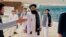 The Taliban-appointed Foreign Minister Amir Khan Muttaqi (center) walks with other officials after arriving in Islamabad for talks with Pakistani officials in May. 
