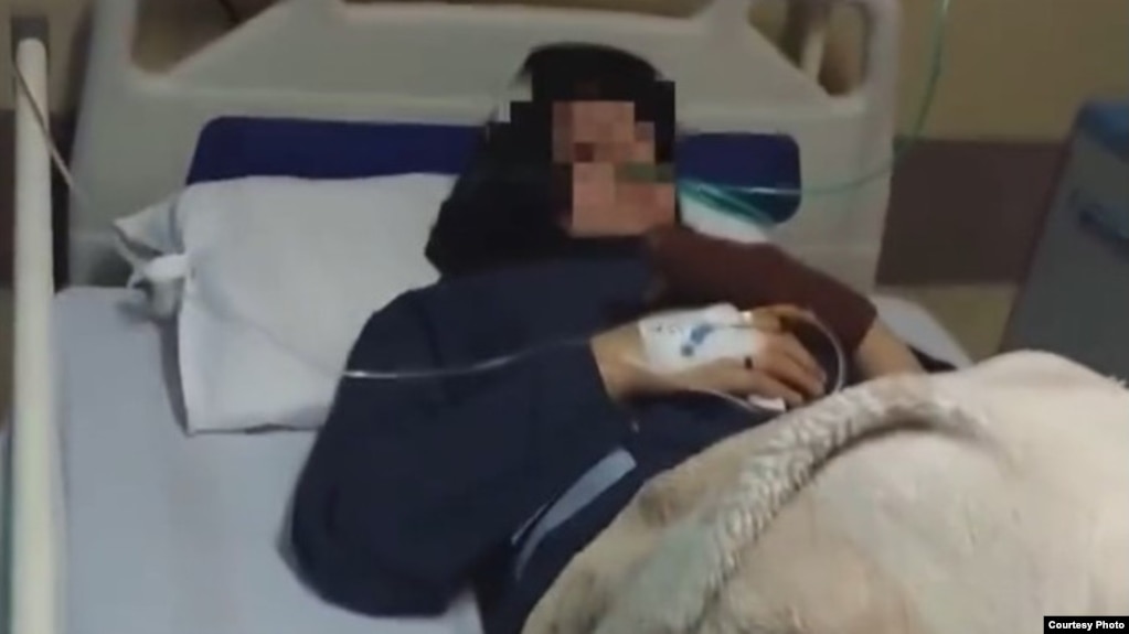 A female student of a school in the city of Qom is seen in a hospital after feeling sick.