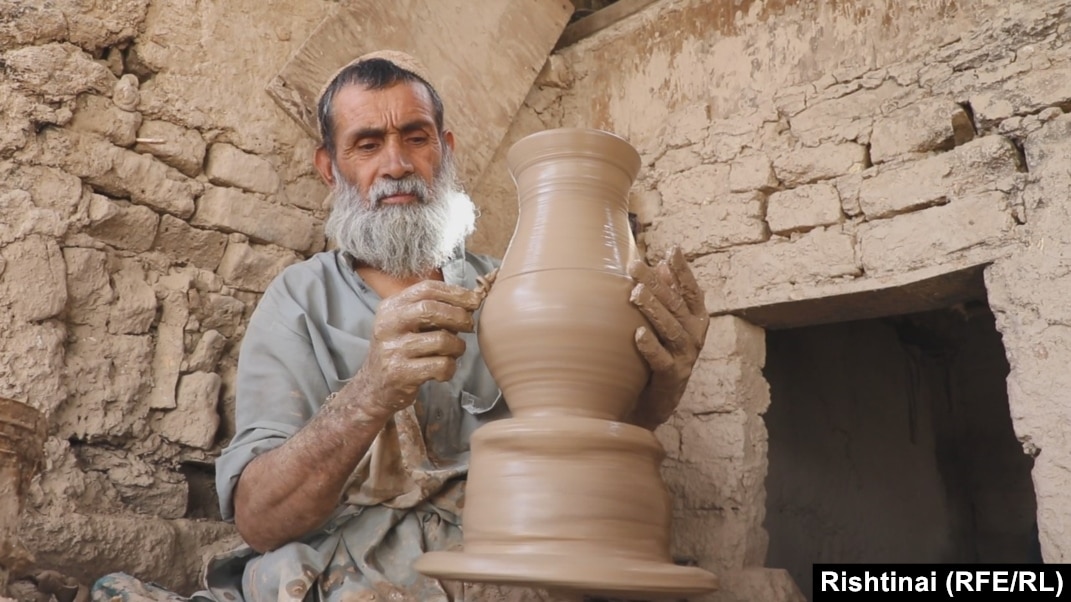 Potter at work at his pottery wheel 