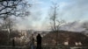 Women watch as smoke rises above the city of Kyiv following a Russian missile attack on December 29.<br />
<br />
Russian forces overnight carried out the &quot;largest air attack&quot; on Ukraine since the beginning of the war, the Ukrainian military&#39;s commander in chief, General Valeriy Zaluzhniy, said.