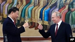 Chinese leader Xi Jinping and Russian President Vladimir Putin toast during a March summit in Moscow.