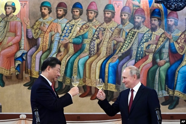 Chinese leader Xi Jinping and Russian President Vladimir Putin toast during a March summit in Moscow.