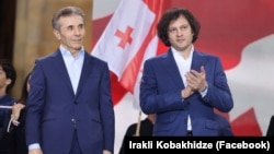 Georgian Dream's billionaire founder and honorary chairman, Bidzina Ivanishvili (left), alongside Prime Minister Irakli Kobakhidze at a party rally in Tbilisi on April 29. They say the bill boosts "transparency."