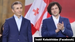 Georgian Dream founder Bidzina Ivanishvili (left) and Prime Minister Irakli Kobakhidze at a party rally in Tbilisi in April. 