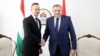 Hungarian Foreign Minister Peter Szijjarto (left) and Bosnian Serb leader Milorad Dodik shake hands at a meeting last year.