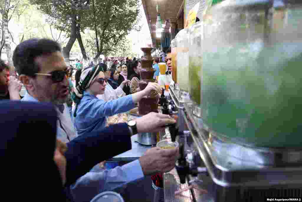 People in Tehran try to cool off with cold drinks. With its rivers and lakes drying up and prolonged droughts becoming the norm, the heat wave is highlighting a water crisis in Iran that is turning much of the country&rsquo;s territory to dust.