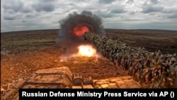 In an image released by the Russian Defense Ministry on April 4, a Russian tank fires in an undisclosed location in Ukraine.