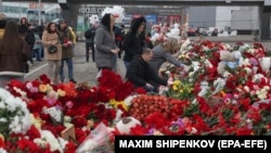 People mourn and bring flowers to the Crocus City Hall concert venue following a terrorist attack in Krasnogorsk, outside Moscow, on March 25.