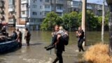 GRAB Fleeing Floods, Ukrainians Make Perilous Boat Journeys To Safety