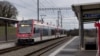 A train passes through the station close to where an Iranian man armed with an axe and a knife held 15 hostages on a train for almost four hours until police stormed the train and fatally wounded him late on February 8, in Essert-sous-Champvent, Switzerland.