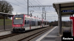 A train passes through the station close to where an Iranian man armed with an axe and a knife held 15 hostages on a train for almost four hours until police stormed the train and fatally wounded him late on February 8, in Essert-sous-Champvent, Switzerland.