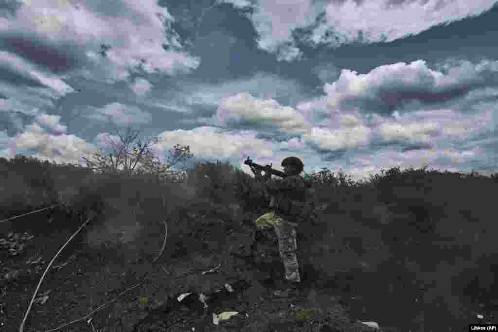 A Ukrainian soldier fires an RPG toward enemy positions from his trench. Moscow says capturing Bakhmut opens the way to further advances in the eastern industrial Donbas region bordering Russia. Kyiv says its advance on the Russian forces&#39; flanks is more meaningful than its withdrawal inside Bakhmut itself, and Russia will have to weaken its lines elsewhere to send reinforcements to hold the shattered city.