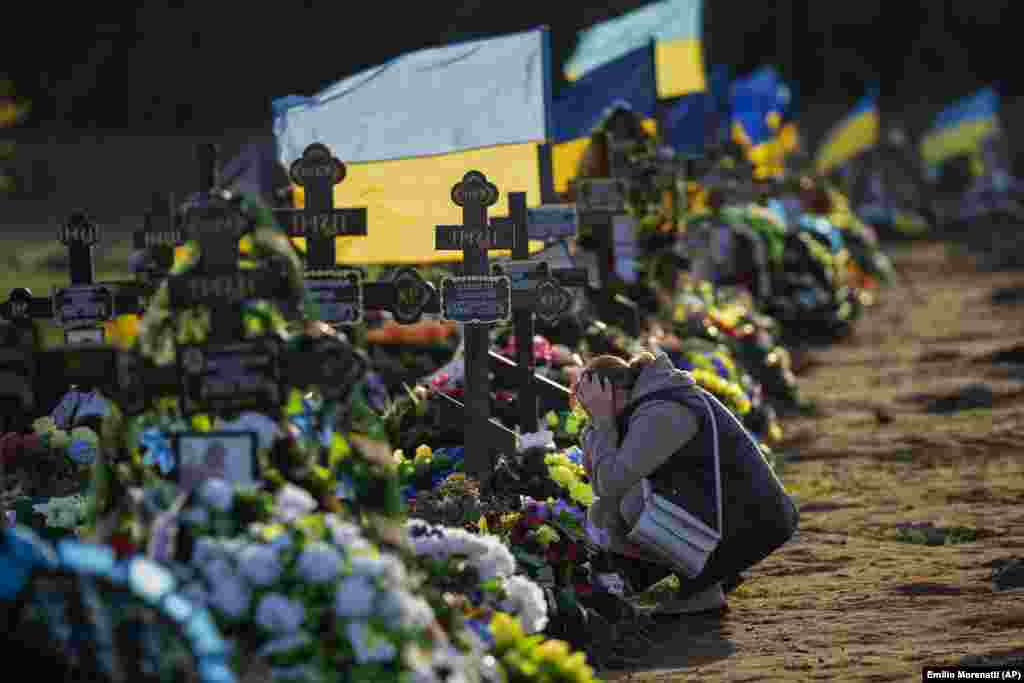 At a cemetery in Mykolayiv, southern Ukraine, in October 2022, a woman weeps at the grave of her only son, a soldier killed by a Russian bombardment.