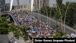 Romanian teachers march in Bucharest on June 9.