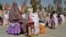 Afghan women sit after receiving food aid distributed by a charity foundation during the Muslim holy fasting month of Ramadan in Kandahar on March 28.