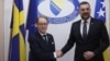 Swedish Foreign Minister Tobias Billstroem (left) shakes hands with Bosnian counterpart Elmedin Konakovic in Sarajevo on April 20.