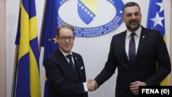 Swedish Foreign Minister Tobias Billstroem (left) shakes hands with Bosnian counterpart Elmedin Konakovic in Sarajevo on April 20.