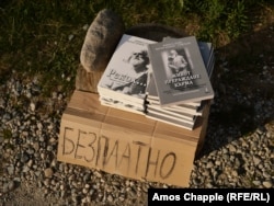 Books about Peter Deunov on a roadside in the Rila Mountains on August 17. The handwritten sign says “free of charge.”