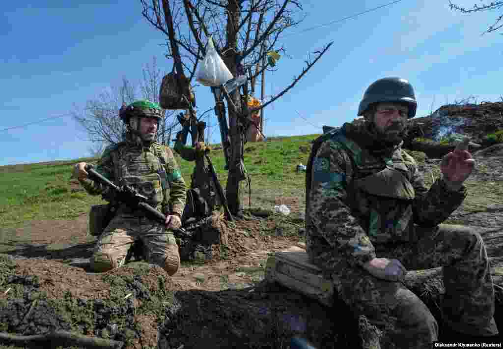 Ukrainian soldiers during a lull in the fighting near a trench in Bakhmut on April 10. Kyiv claims its defense of Bakhmut is inflicting huge losses on the Russian invaders, but acknowledges that its own forces have paid the price, as well.
