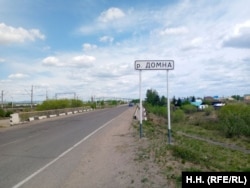 Një shenjë pranë rrugës tregon fillimin e vendbanimit Domna.