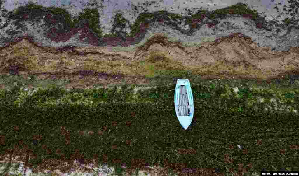 A boat on the receding shoreline of&nbsp;Lake Prespa