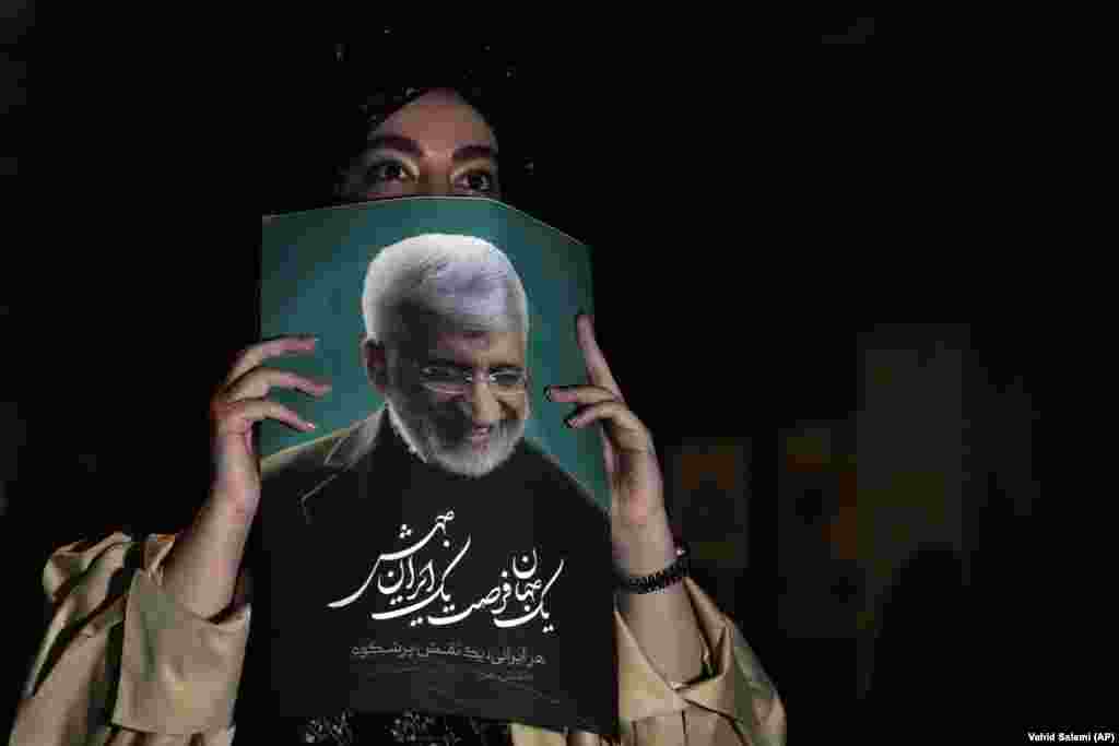 A supporter of Jalili holds up a poster. No candidate is expected to secure enough votes on June 28 to be declared the outright winner in the tightly controlled contest.