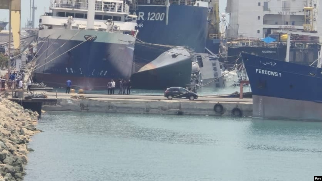 The Iranian destroyer Sahand is seen capsized in the port of Bandar Abbas.