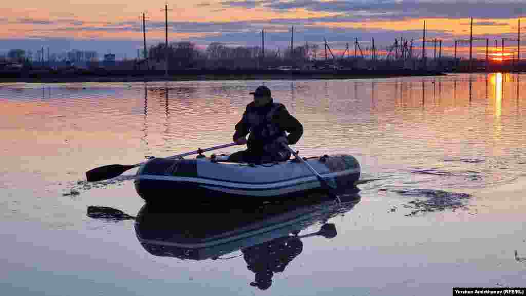 A man rows a dinghy around the village of Bolshaya Malyshka in North Kazakhstan Province, which has seen weeks of record-setting spring floods.