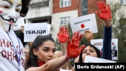 Protesters with hands painted red chant "murderers!" in front of the government building in Skopje on September 4.