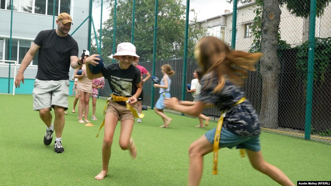 RFE/RL's Austin Malloy films a football drill at the Vinnytsya Wolves youth clinic.