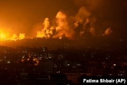 Fire and smoke rise following an Israeli air strike on Gaza City on October 8.